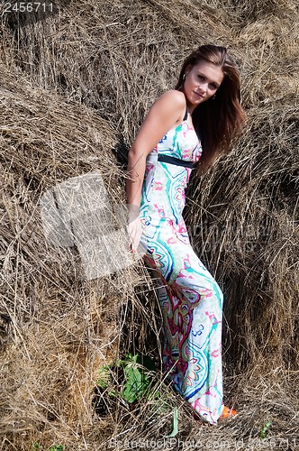 Image of Young beautiful woman on hay