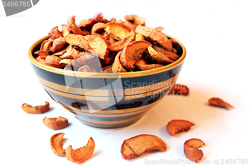 Image of dried apples in the plate on the white background