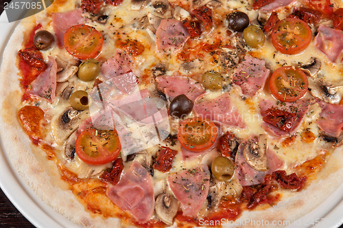 Image of pizza with ham and mushrooms