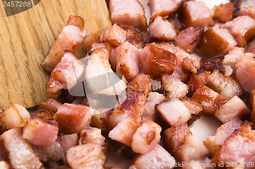 Image of Macro photo of bacon being fried in a pan