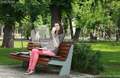 Image of Woman Drinking Coffee in a Park