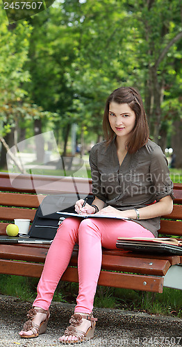 Image of Woman Wiritng Outside in a Park
