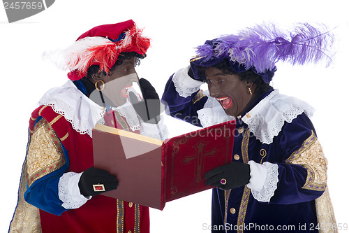 Image of Zwarte Piet and the book of Sinterklaas