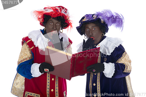 Image of Zwarte Piet and the book of Sinterklaas