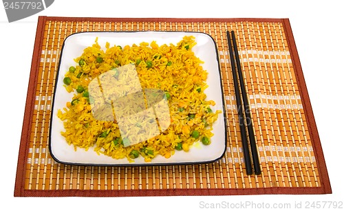 Image of Rice with vegetables and chopsticks on bamboo mat