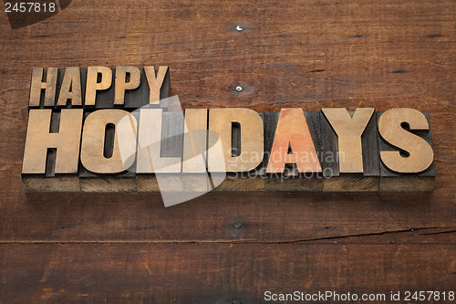 Image of happy holidays in wood type
