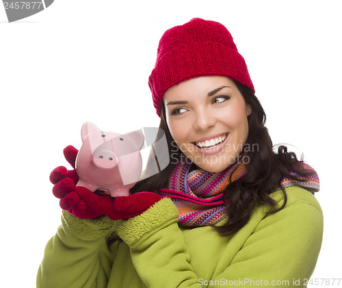 Image of Mixed Race Woman Wearing Winter Hat Holding Piggybank on White 