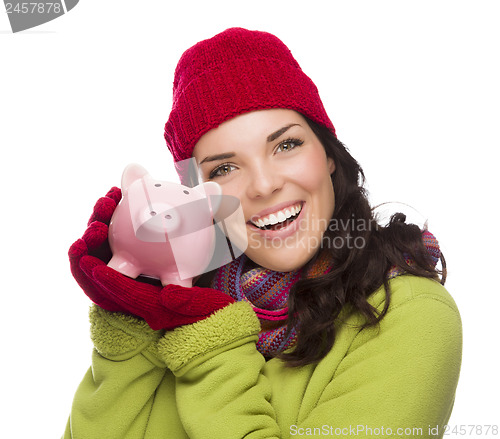 Image of Happy Mixed Race Woman Wearing Winter Hat Holding Piggybank