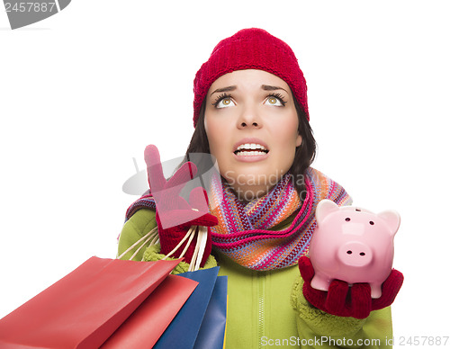 Image of Stressed Mixed Race Woman Holding Shopping Bags and Piggybank