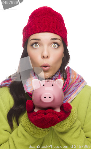 Image of Expressive Mixed Race Woman Wearing Winter Hat Holding Piggybank