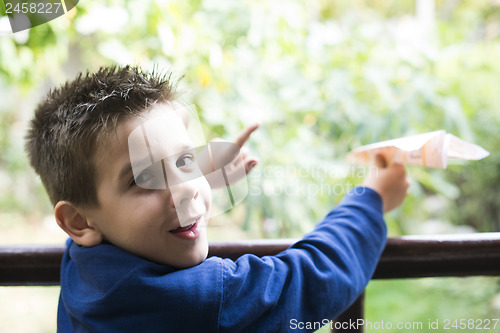 Image of Kid throws paper plane