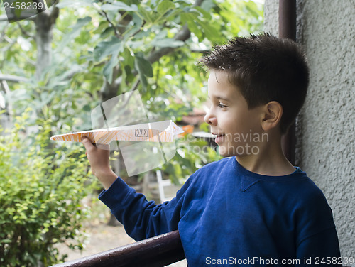 Image of Kid throws paper plane