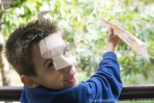 Image of Kid throws paper plane