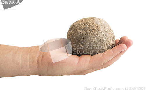 Image of Hand holding stone ball