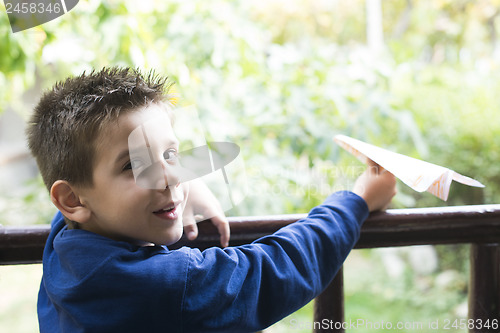 Image of Kid throws paper plane