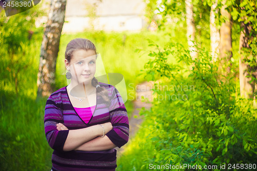 Image of A Beautiful Young Girl Standing On A Forest Path Road