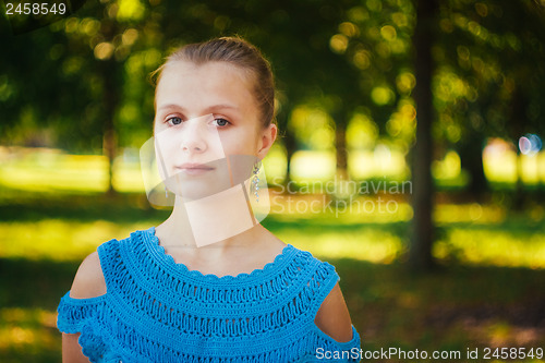 Image of Beautiful young girl in the park 