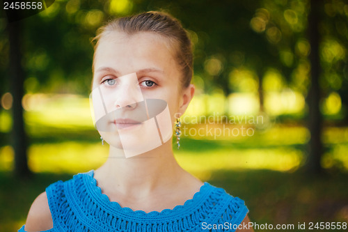 Image of Beautiful young girl in the park 