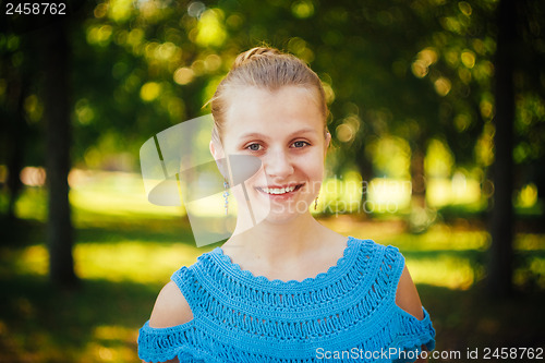 Image of Beautiful young girl in the park 