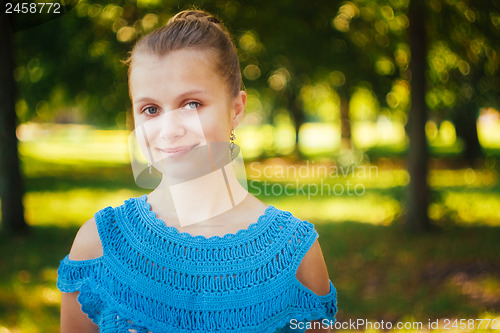 Image of Beautiful young girl in the park 