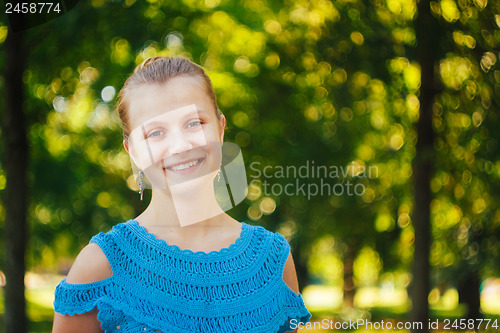 Image of Beautiful young girl in the park 