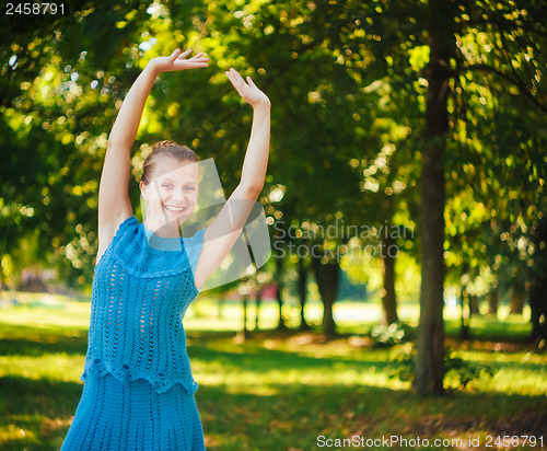 Image of Beautiful young girl in the park 