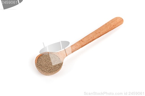 Image of milled black pepper in wooden spoon