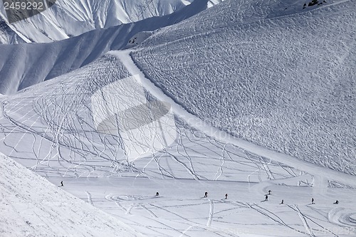 Image of Snowboarders and skiers on groomed slope