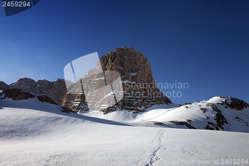 Image of Snowy plateau and footpath against rock and blue sky in nice day