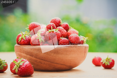 Image of Close-Up Of Strawberries In Vintage Wooden Bowl On Table