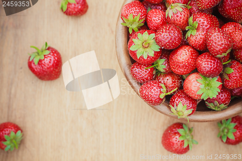 Image of Close-Up Of Strawberries In Vintage Wooden Bowl On Table