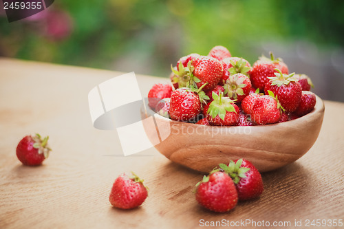 Image of Close-Up Of Strawberries In Vintage Wooden Bowl On Table