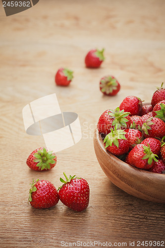 Image of Close-Up Of Strawberries In Vintage Wooden Bowl On Table