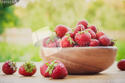 Image of Close-Up Of Strawberries In Vintage Wooden Bowl On Table