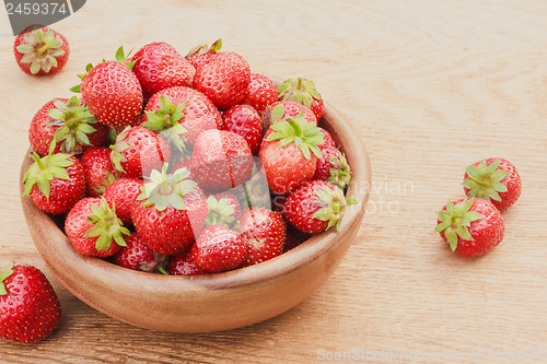 Image of Close-Up Of Strawberries In Vintage Wooden Bowl On Table