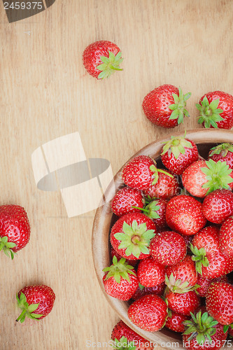 Image of Close-Up Of Strawberries In Vintage Wooden Bowl On Table