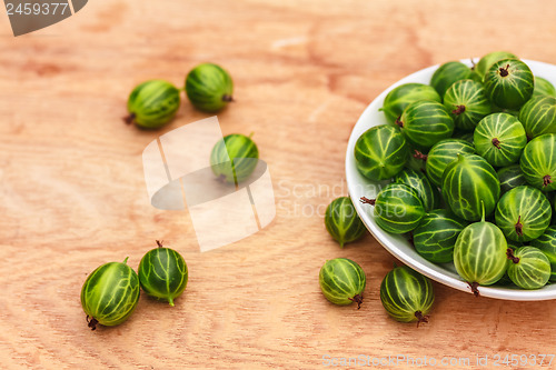 Image of Close-Up Of Gooseberries In Vintage White Dish On Wooden Table