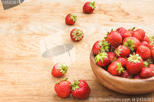 Image of Close-Up Of Strawberries In Vintage Wooden Bowl On Table