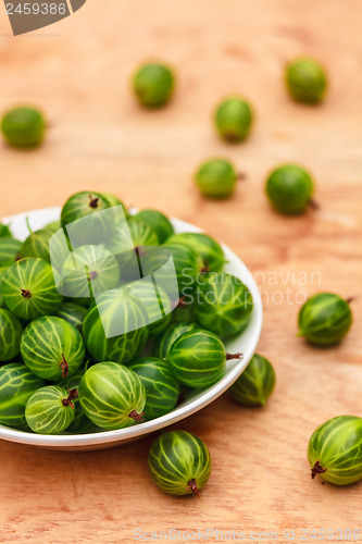 Image of Close-Up Of Gooseberries In Vintage White Dish On Wooden Table