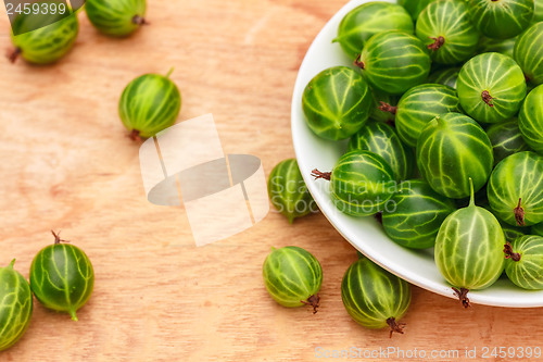 Image of Close-Up Of Gooseberries In Vintage White Dish On Wooden Table