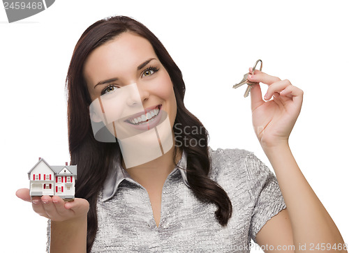 Image of Mixed Race Female Presenting Keys and Holding a Small House
