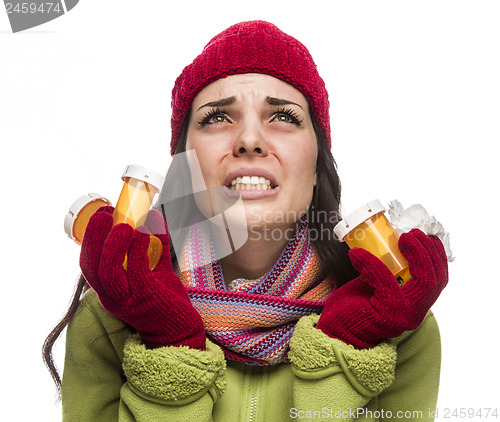 Image of Sick Mixed Race Woman with Empty Medicine Bottles Blowing Nose 
