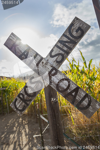 Image of Antique Country Rail Road Crossing Sign Near a Corn Field
