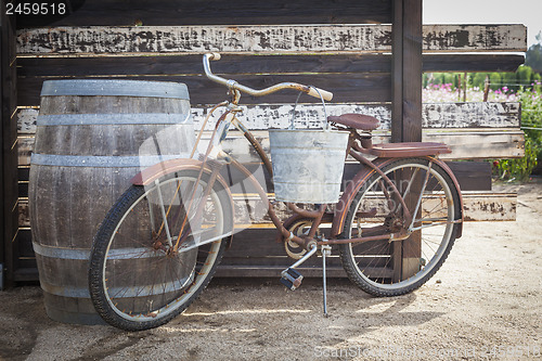 Image of Old Rusty Antique Bicycle and Wine Barrel
