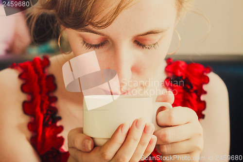 Image of Female Hands Holding A Cup