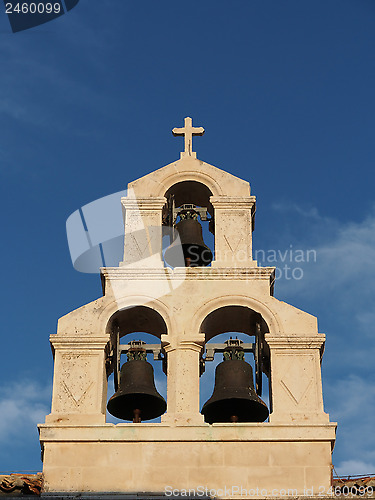 Image of stone bell tower with a blue sky background