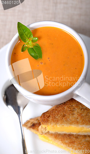 Image of Delicious bowl of tomato soup with grilled cheese sandwich