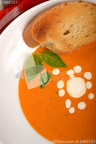 Image of Delicious bowl of tomato soup with grilled bread and basil