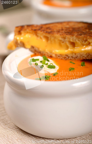 Image of Delicious bowl of tomato soup with grilled cheese sandwich