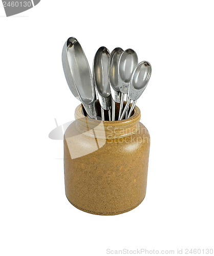 Image of Metal measuring spoons in a ceramic pot